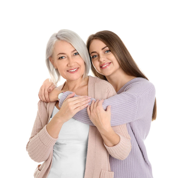 Portrait of young woman with her mature mother on white background - Foto, Bild