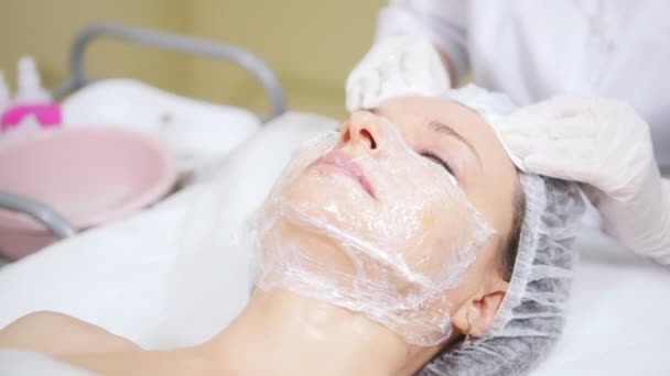 Schoonheidsspecialist reinigt klanten gezicht doen cosmetische ingrepen van Mesotherapie in cosmetologie kliniek. - Video