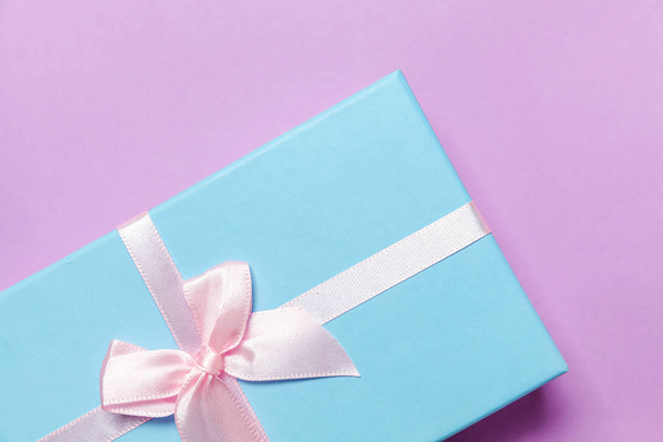 Karácsonyi-újévi születésnap Valentin jelen romantikus fogalmát. Kis ajándék dobozban csomagolva elszigetelt lila lila pasztell színes trendi háttér kék papír. Lapos laikus felülnézet másol hely - Fotó, kép