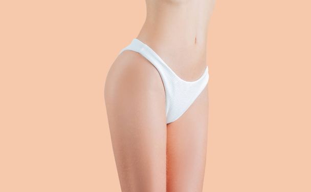 Woman waist. Girl with perfect body shape, flat belly in underwear on pastel background - Fotografie, Obrázek