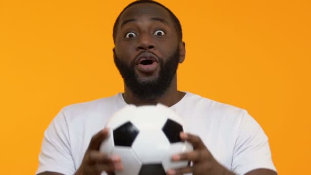 Excited black guy football hands celebrating team goal, sport victory, success - Filmati, video