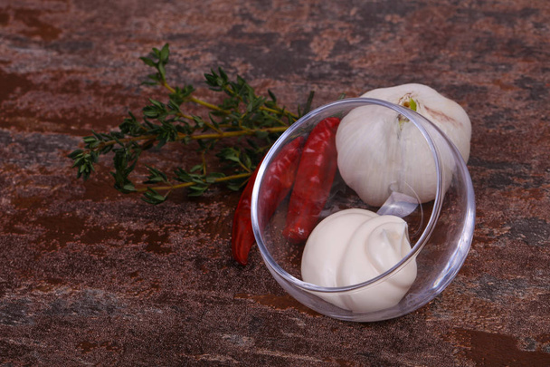Mayonnaise sauce in the white bowl served thyme, red pepper and garlic - Photo, Image