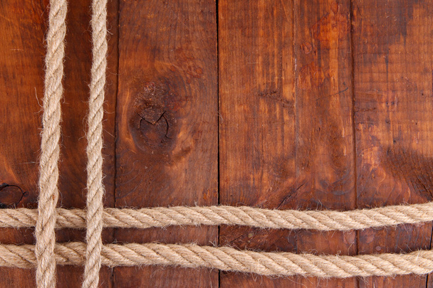 Frame composed of rope on wooden background - Foto, immagini