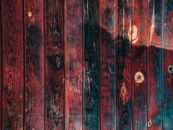 Grungy blue and red pealing paint wooden wall texture in old vintage background - 写真・画像