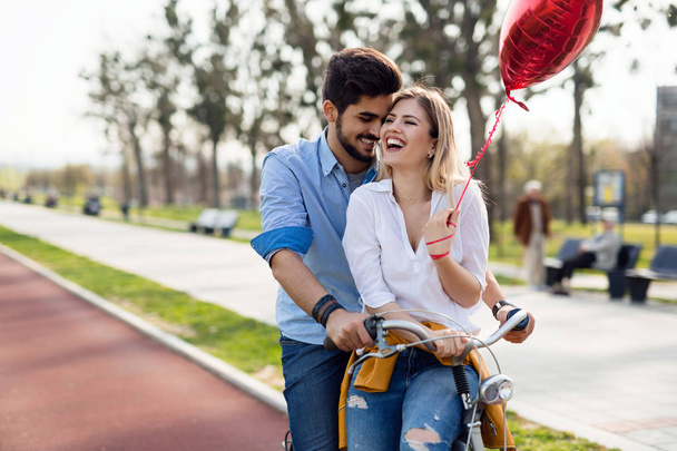 Beautiful couple in love riding bicycle in city and dating - Foto, Bild