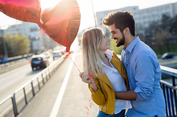 summer holidays, celebration and dating concept - happy couple with colorful balloons - Фото, зображення