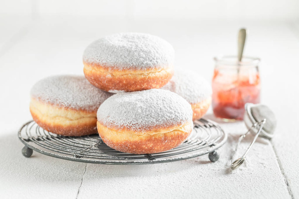 Sweet and brown donuts with white icing - 写真・画像