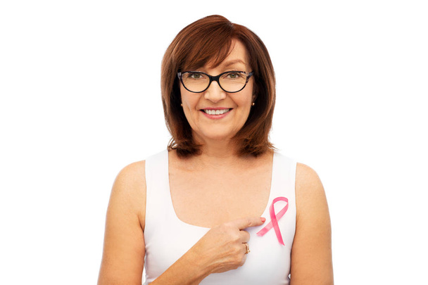 old woman with pink breast cancer awareness ribbon - Valokuva, kuva