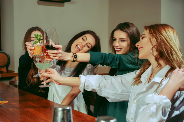 Friends having a drinks at bar - Фото, изображение