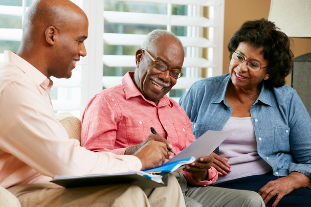 Financial Advisor Talking To Senior Couple At Home - Фото, изображение