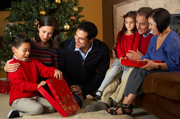 Multi Generation Family Opening Christmas Presents In Front Of T - Valokuva, kuva