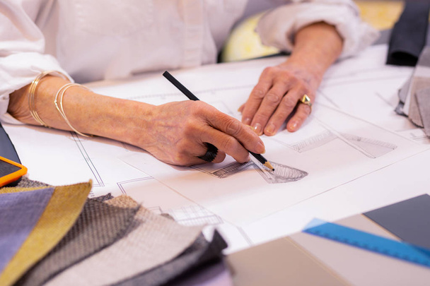 Close-up photo of elderly leading designer making drawing at desk - Φωτογραφία, εικόνα