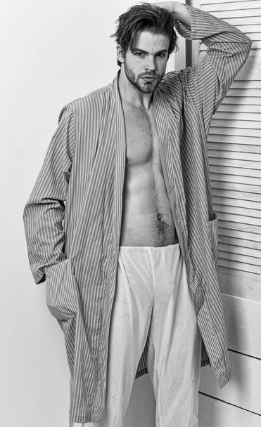 Macho in bathrobe with strong chest and six packs. - Photo, Image