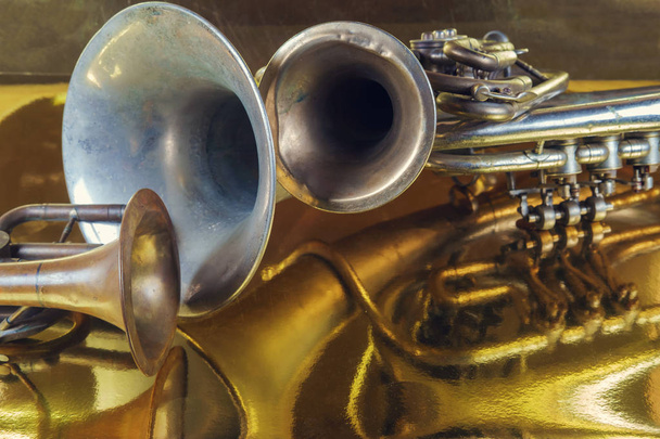 Brass instruments reflected on a golden surface - Photo, Image