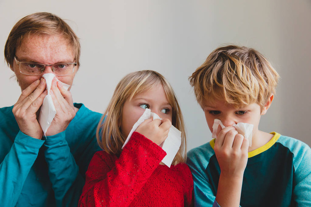 father and kids wiping and blowing nose, infection or allergy - Φωτογραφία, εικόνα