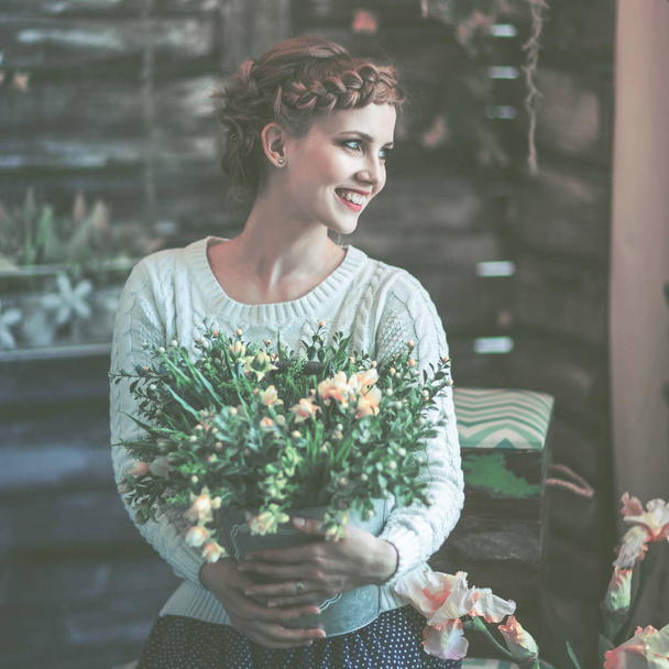 portrait of a beautiful happy young woman with a bouquet of flowers - Фото, зображення
