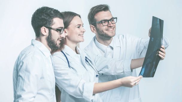  group of diagnosticians with x-rays on a white background - Фото, изображение