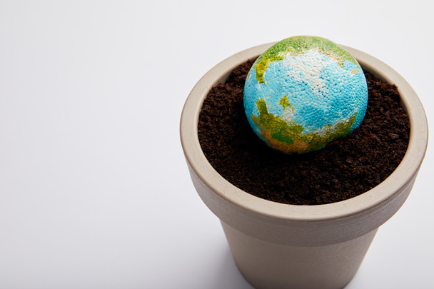 bolygó modell forgalomba virágcserép, talaj, föld napja koncepció - Fotó, kép