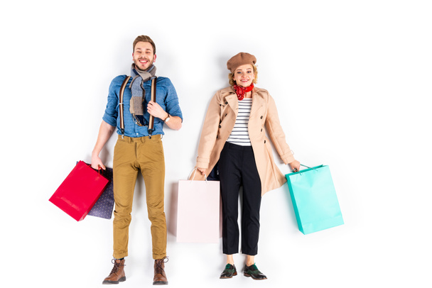 Stylish smiling couple holding shopping bags on white background - Foto, Imagem