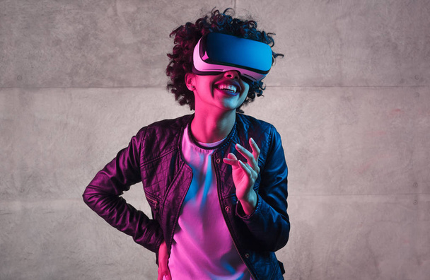 Trendy teenager in VR headset laughing - Фото, зображення