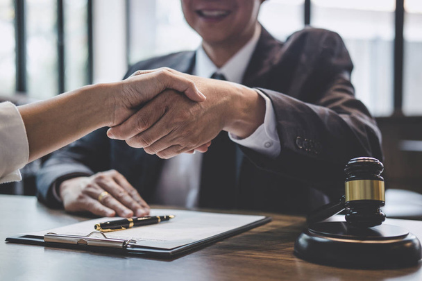 Good service cooperation of Consultation between a male lawyer and business woman customer, Handshake after good deal agreement, Law and Legal concept. - Fotoğraf, Görsel