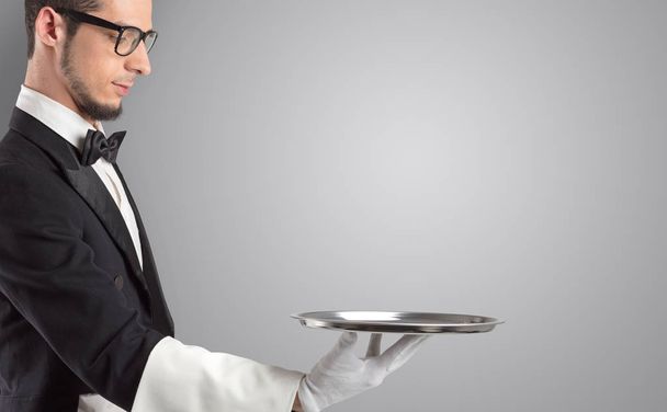 Waiter serving with white gloves and steel tray - Fotó, kép