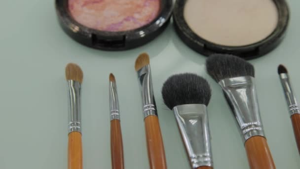 Set of brushes for make-up on table in dressing room. Fashion industry. Fashion show backstage - Footage, Video