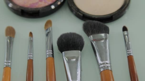 Set of brushes for make-up on table in dressing room. Fashion industry. Fashion show backstage - Footage, Video