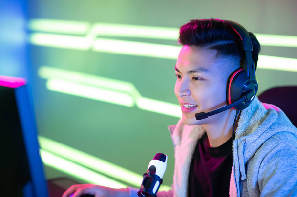 close up of Young Asian Handsome Pro Gamer having live stream and playing in Online Video Game - Fotó, kép