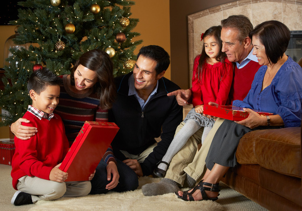 Multi Generation Family Opening Christmas Presents In Front Of T - Valokuva, kuva