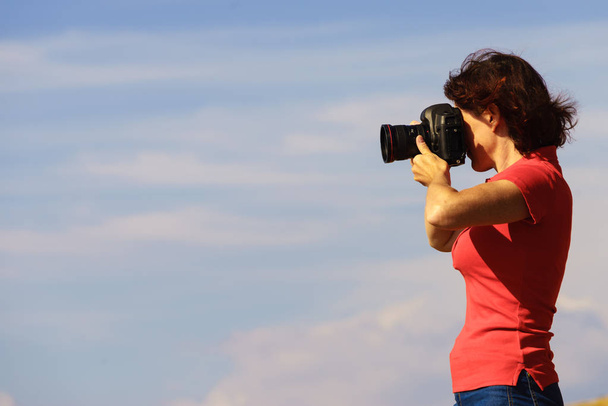 Tourism vacation and travel. Woman tourist on nature taking photo with camera. - Foto, immagini