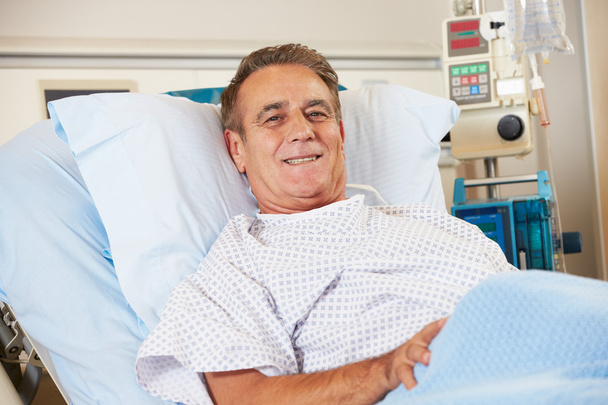 Portrait Of Male Patient Relaxing In Hospital Bed - Photo, image