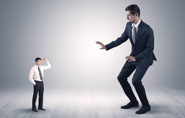 Giant businessman scared of small businessman - Photo, Image