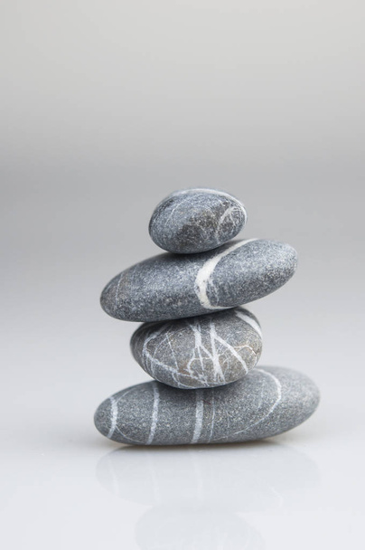 Balanço zen seixos pedras cinza e branco sobre fundo branco
 - Foto, Imagem