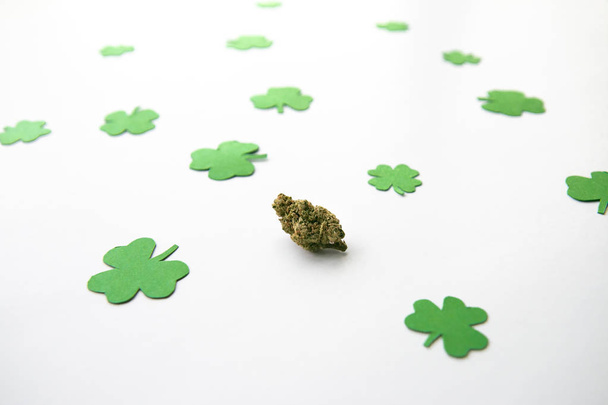Marijuana Bud against Four and Three Leaf Clovers St Patricks St Pattys Day - High Angle, Centered - Photo, Image