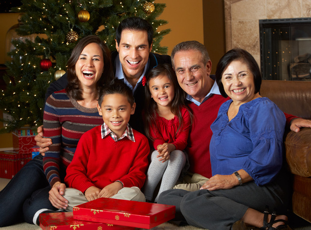 Multi Generation Family Opening Christmas Presents In Front Of T - 写真・画像