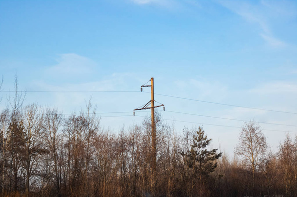 A pole with electric wires against a blue sky, copy space - Φωτογραφία, εικόνα