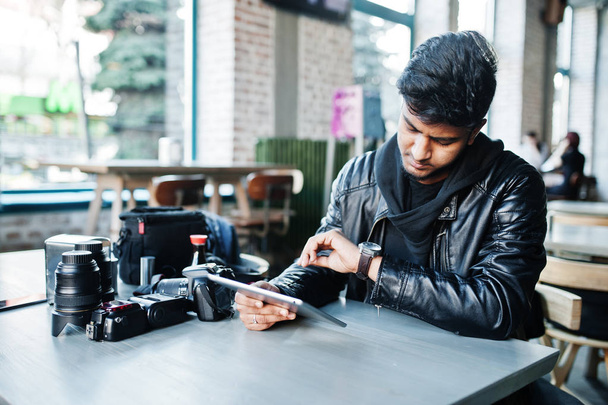 Smart young asian man photographer working with tablet during sitting at cafe and looking at his watches. - Φωτογραφία, εικόνα