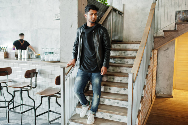 Casual and stylish young asian man wear on leather jacket standing on stairs at cafe. - Zdjęcie, obraz