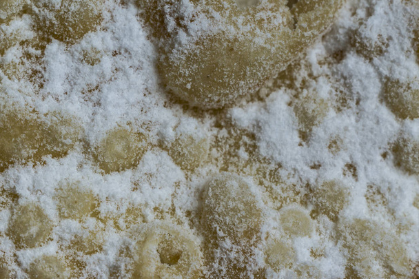 Macrophoto. European dessert angel wings. Interesting tech tour deep fried dough strips with powdered sugar. Site about the kitchen, pastries, sweets. - Photo, Image