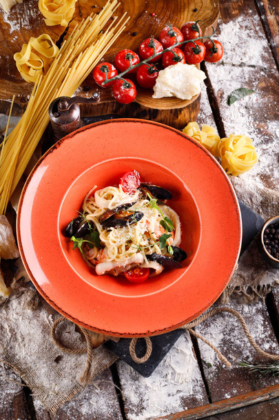 Pasta with fresh seafood, ingredients for cooking, tomatoes, pasta - Fotó, kép