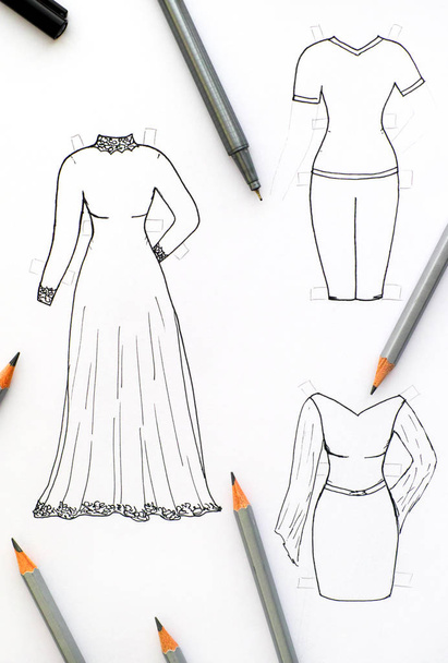Hand drawing clothes for paper doll with black pen and pencils. - Foto, afbeelding
