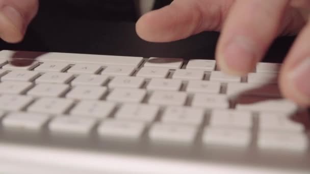 Blurred movie. Hands typing on white keyboard - Footage, Video