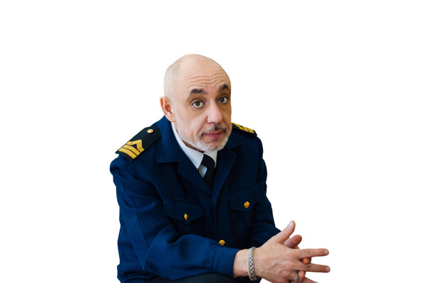 elderly man in an officer sea uniform the sailor looks thoughtfully at the camera, thinking about something, fingers crossed, isolated on white background - Photo, Image