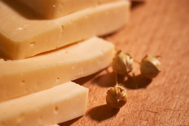 Traditional Dutch semi hard cheese served close up on rural table with sacking. Selective focus - Fotografie, Obrázek