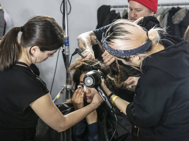 New York, NY - February 13, 2019: A model prepares backstage for the Boss Fall Winter 2019 fashion show during New York Fashion Week - Photo, Image