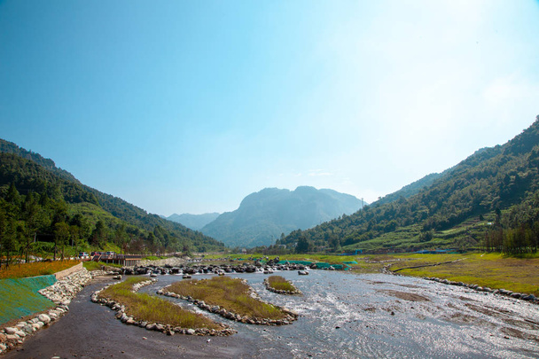 Mooie achtergrond met uitzicht op de rivier berg in Sichuan, China. Weerspiegeling van de berg in de waterige oppervlakte, grote rivier met rotsen en kleine waterval.  - Foto, afbeelding