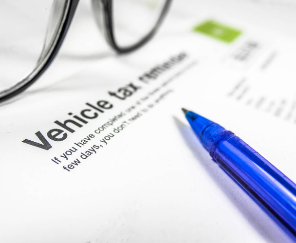 Detail of A Vehicle Tax Reminder Letter Or Form With Glasses And Pen On A Desk With Copy Space - Photo, Image