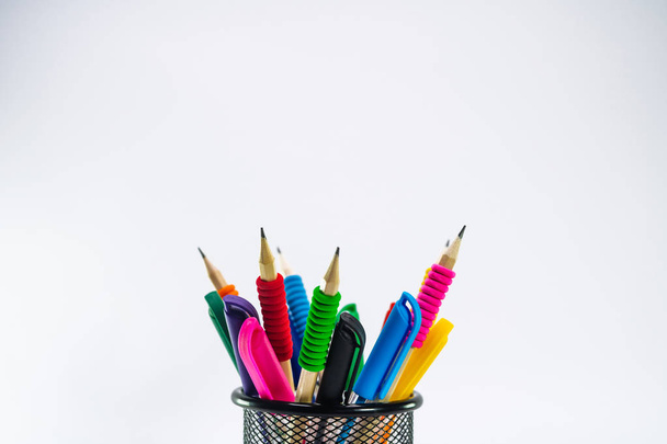 Colored pencils in a pencil case on white background - Foto, afbeelding