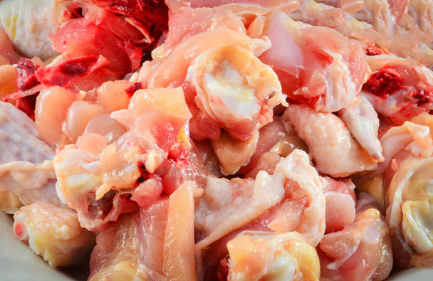 piece fresh raw chicken chopped with bone on plate for cook - Photo, Image